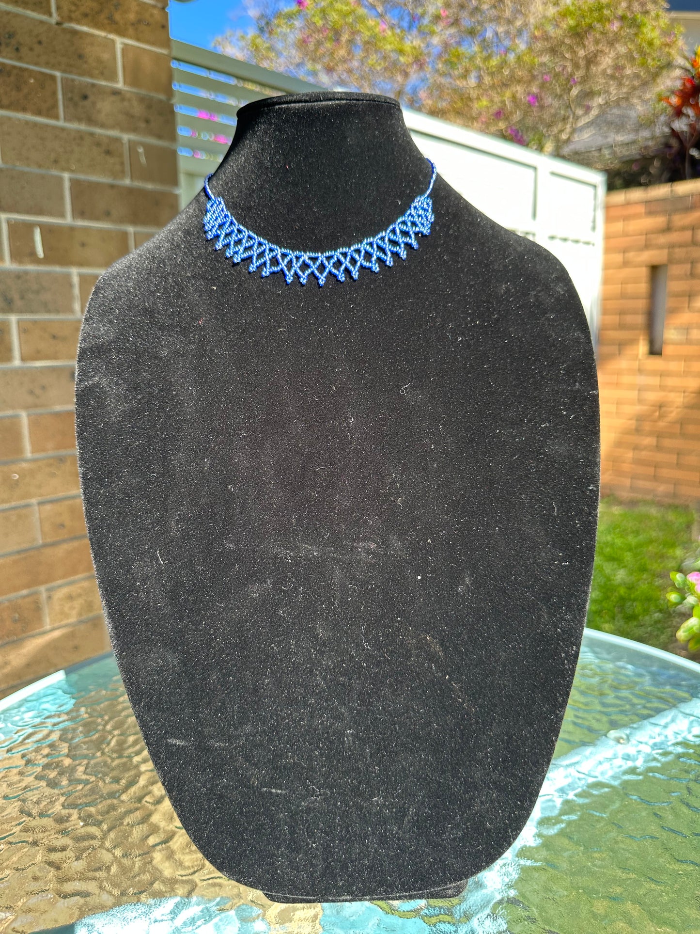 Intricate woven blue beaded necklace